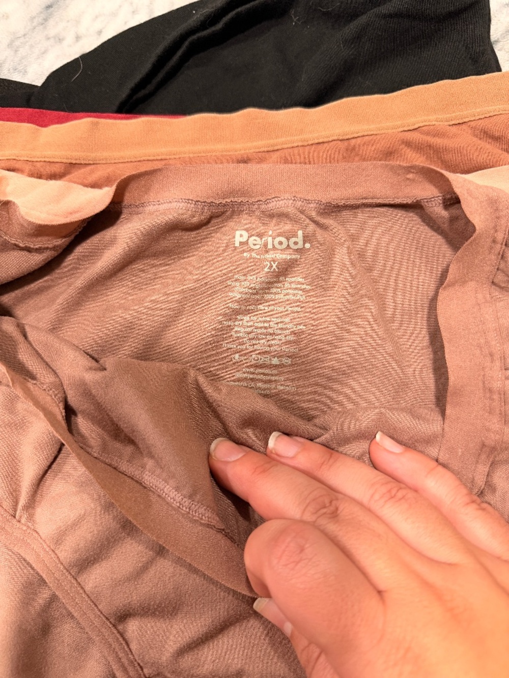 Bundle of period underwear, boxer shorts, and extra heavy overnight shorts